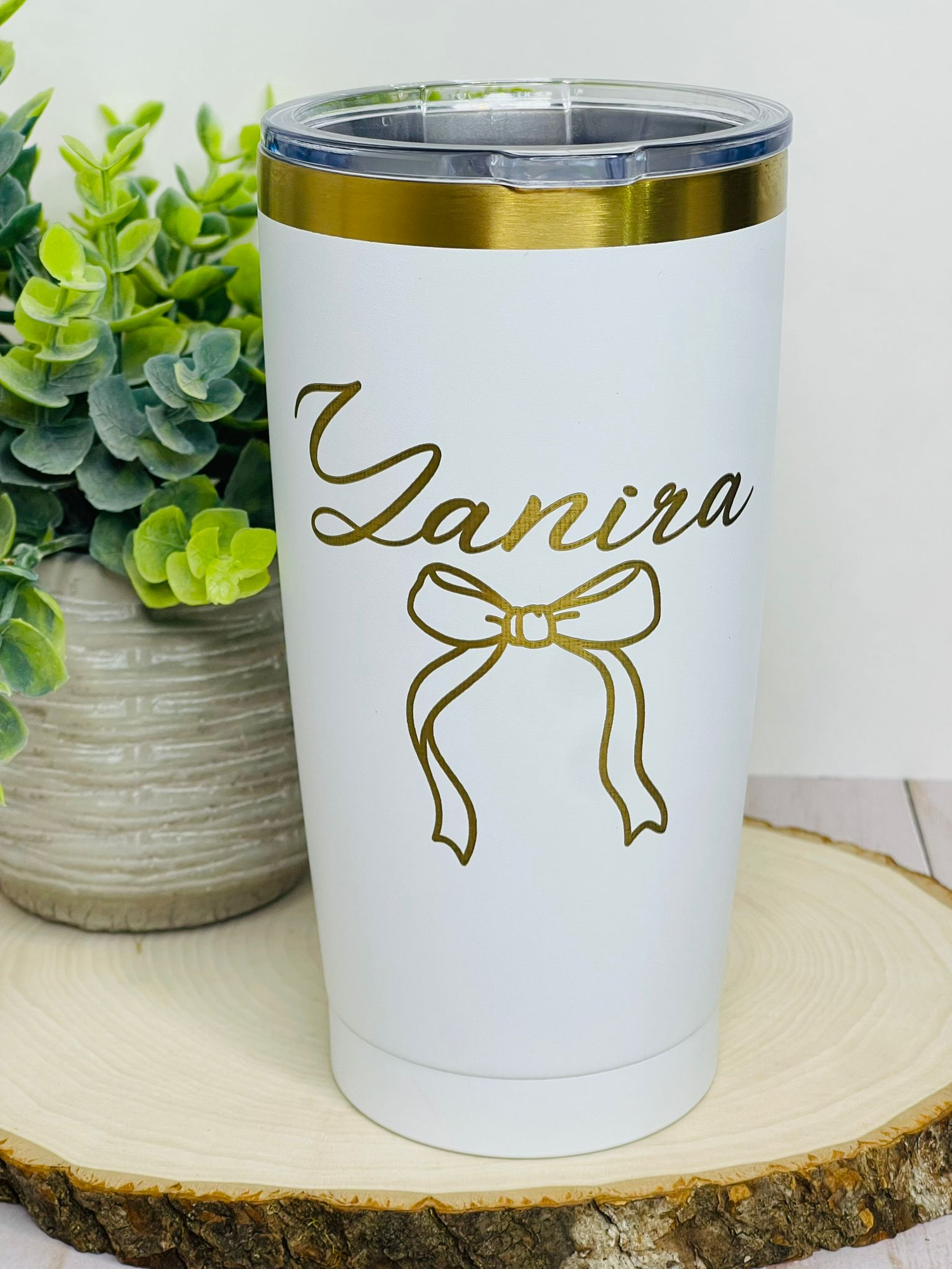 Elegant white and gold personalized tumbler with custom name and bow design, perfect for gifts and special occasions.