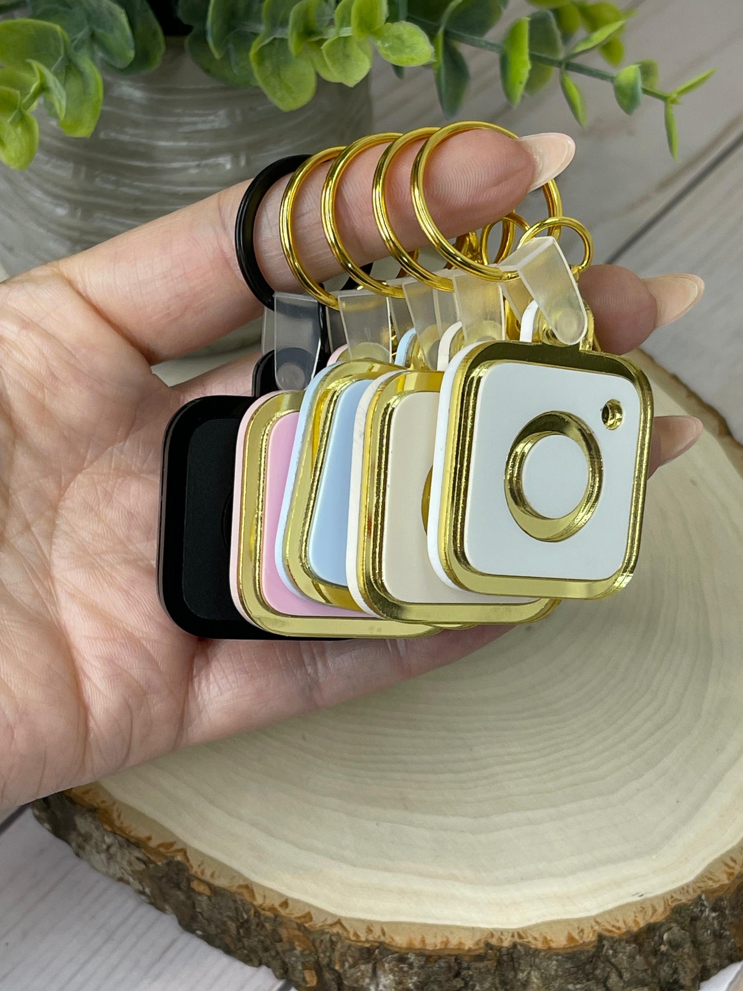 A collection of NFC keychains in various colors, including black, gold, silver, and pastel shades, showcasing customizable options for every style.